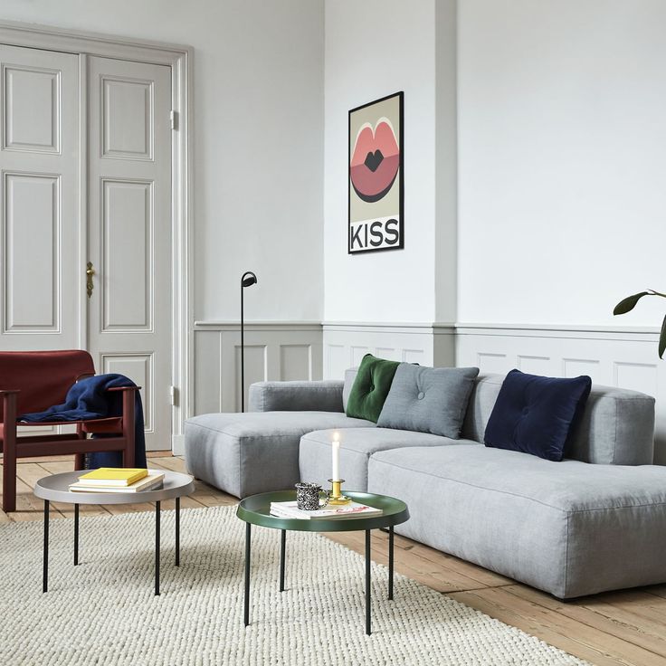 a living room with white walls and wooden floors