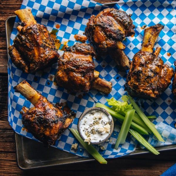 chicken wings and green beans on a blue checkered plate