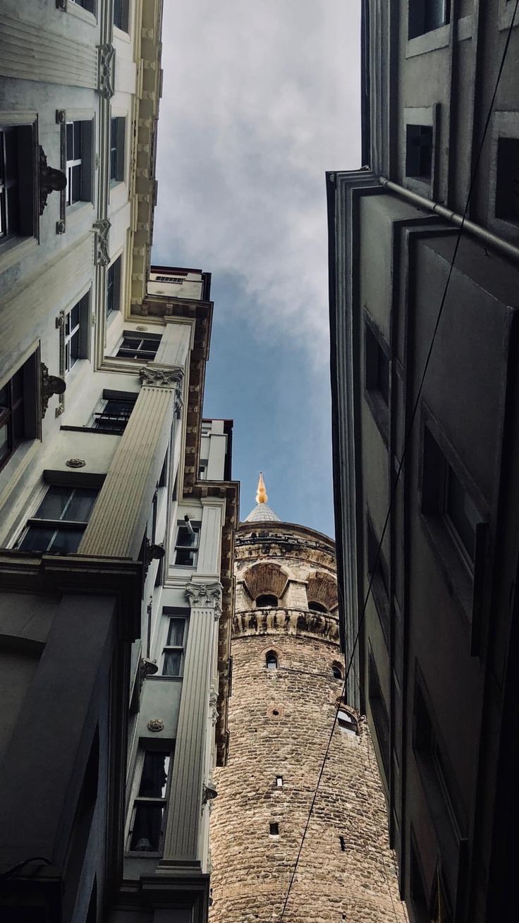 looking up at an old building in the city from another one's perspective,