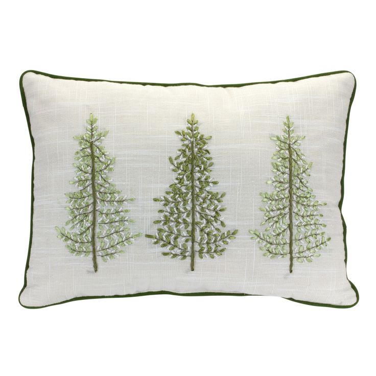 three trees embroidered on a white pillow with green piping and trimmings in the middle