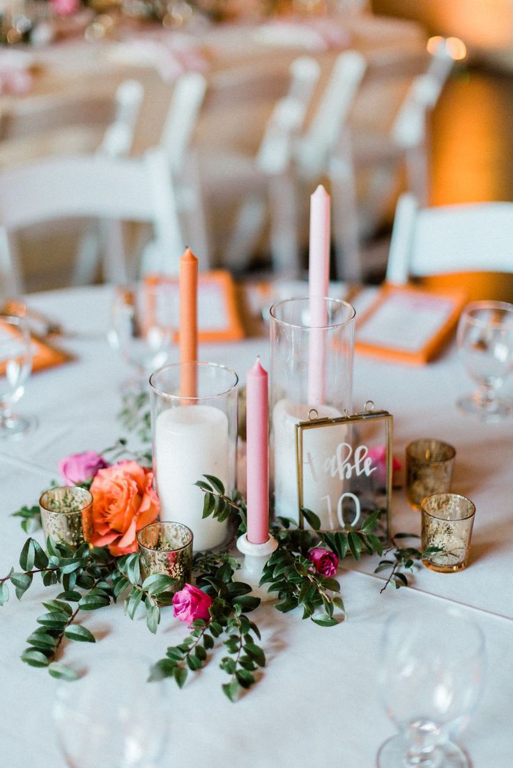 the table is set with candles, flowers and napkins for an elegant wedding reception