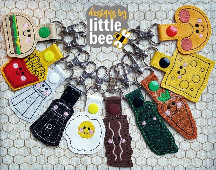 the little bee keychains are all made out of felt and have different designs on them