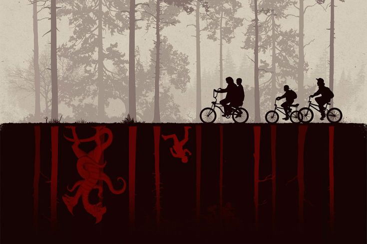 three people riding bikes in the woods on a foggy day with trees and red paint