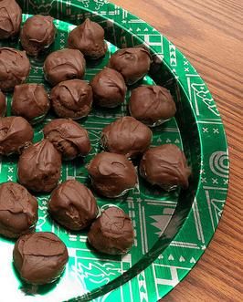 there are chocolate truffles on a green plate