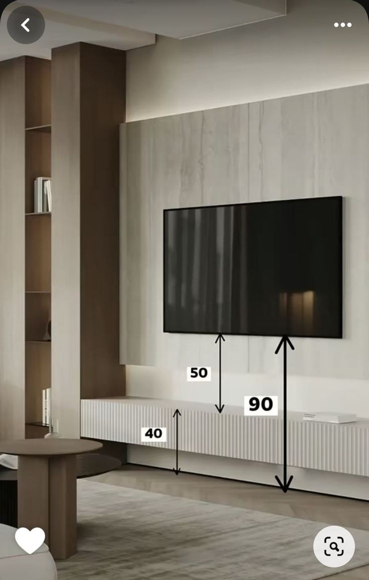 a living room with a large flat screen tv mounted to the wall and measurements for each piece of furniture