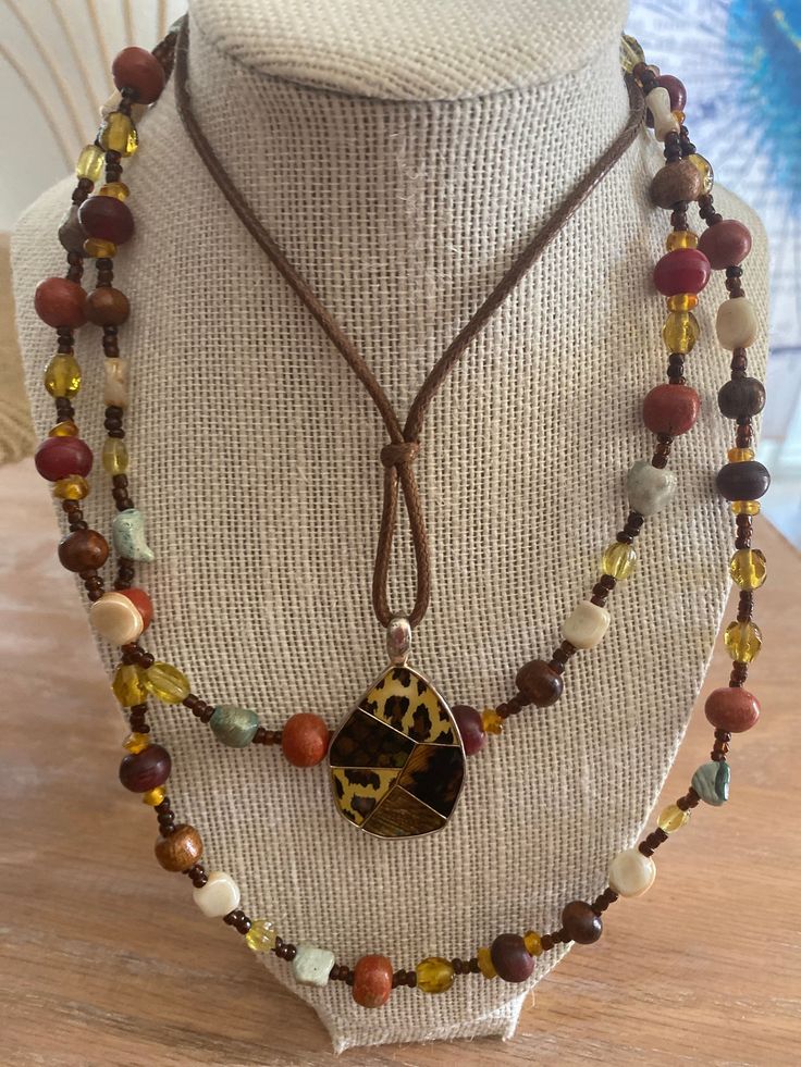 Animal print pendant brown leather rope and long beaded necklace Necklaces Long, Jewlery Necklace, Flapper Necklace, Red Beaded Necklaces, Brown Necklace, Gold Bead Necklace, Long Beaded Necklace, Wood Necklace, Beaded Animals