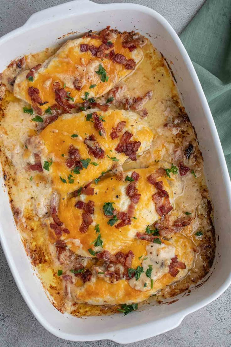 a casserole dish with meat and cheese in it on a gray tablecloth