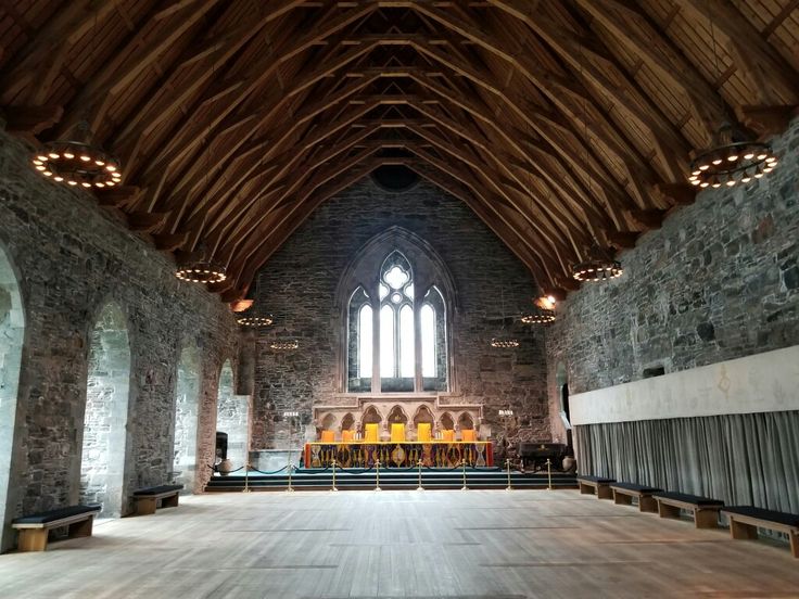 an empty church with stone walls and vaulted ceiling