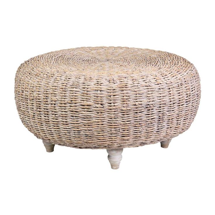 a round wicker ottoman with wooden legs on an isolated white background for use as a coffee table