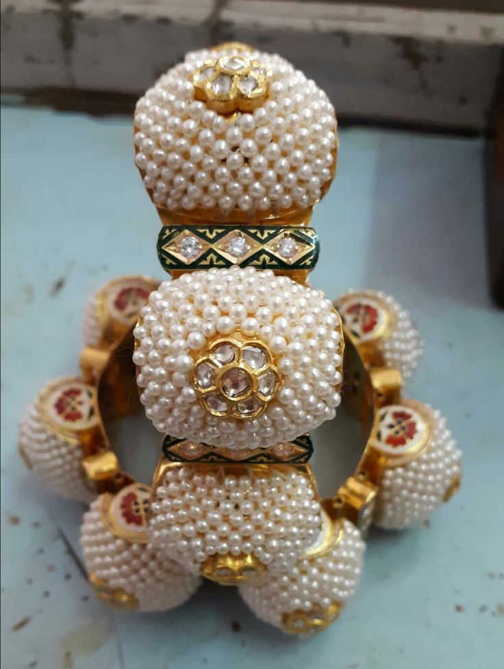 some white beads are stacked on top of each other in the shape of a teddy bear