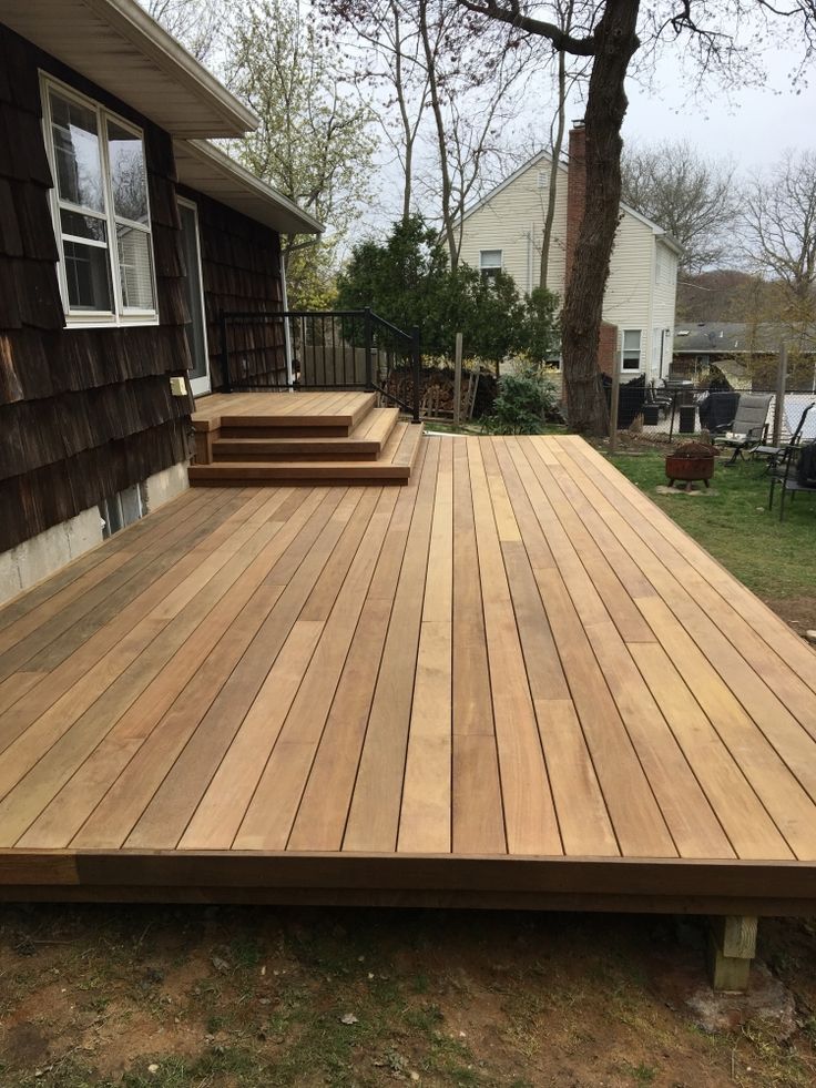 a wooden deck in front of a house