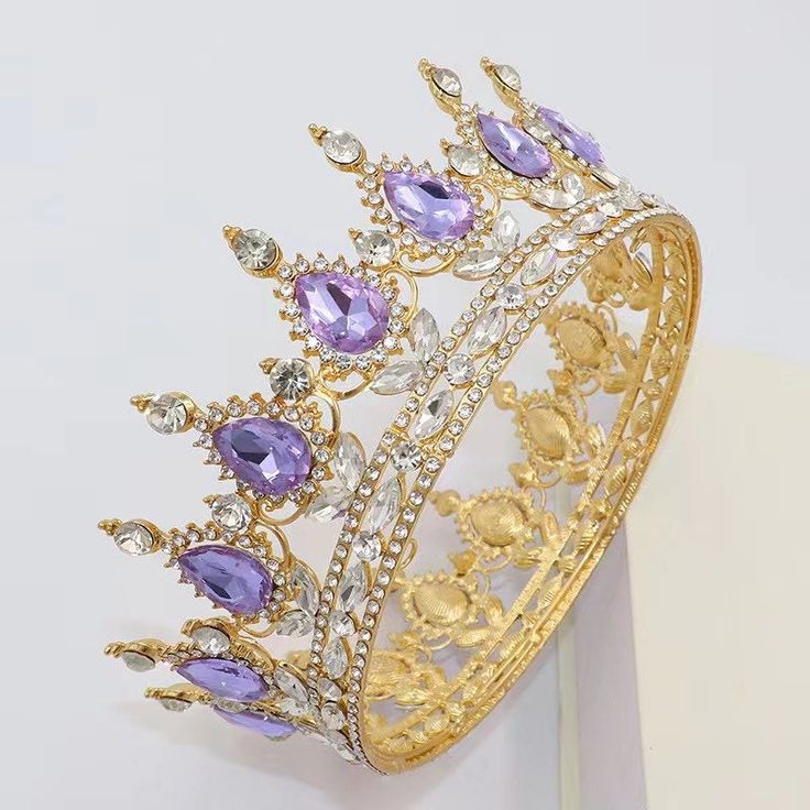 a gold tiara with amethysts and diamonds on it's sides