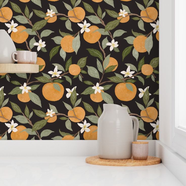 an orange wallpaper with white flowers and green leaves on it, next to a window