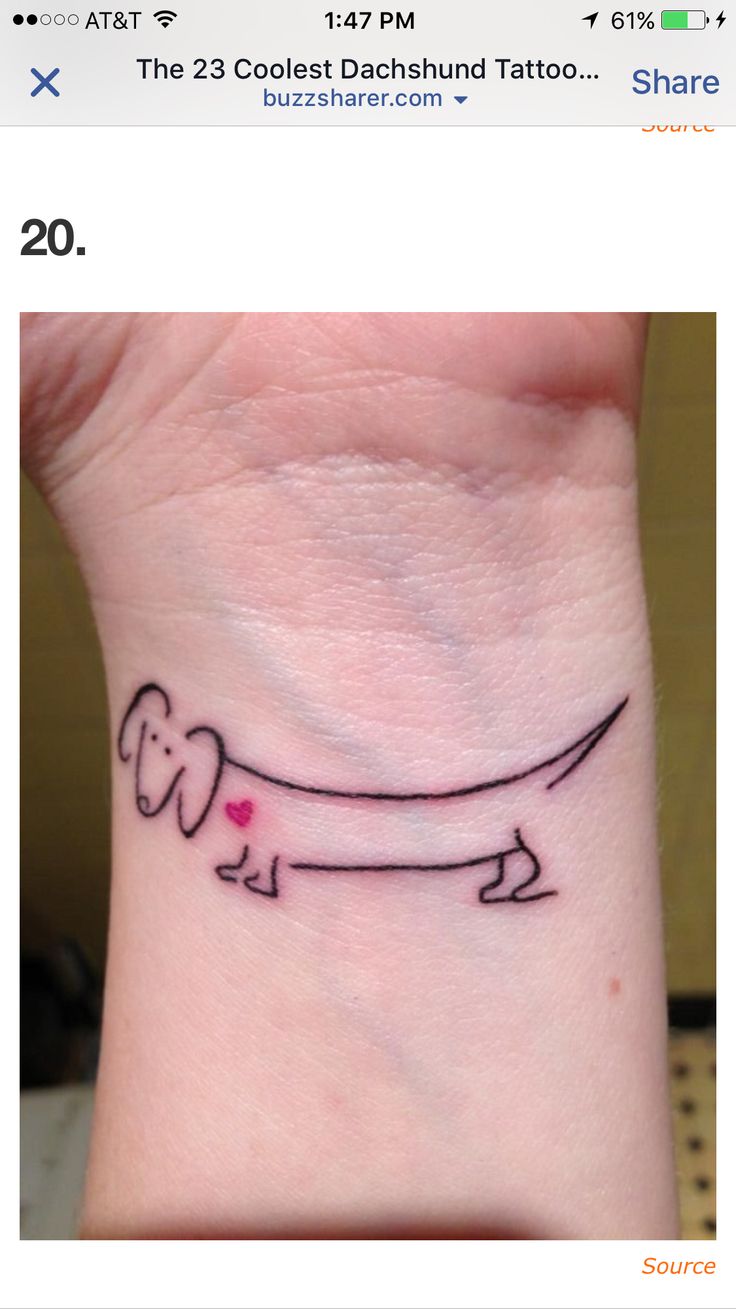 a small tattoo on the wrist of a person with a dog's long tail