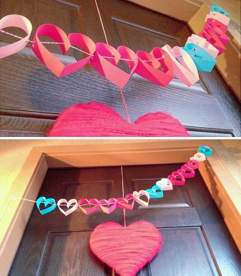 heart shaped paper garlands hanging from the front door to decorate for valentine's day