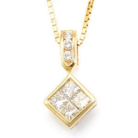 a yellow gold pendant with two square diamonds set in the center, on a chain