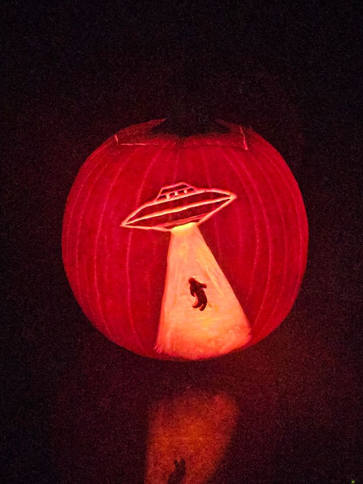 a pumpkin carved to look like an alien ship