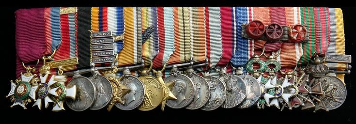 many medals are lined up on a black background