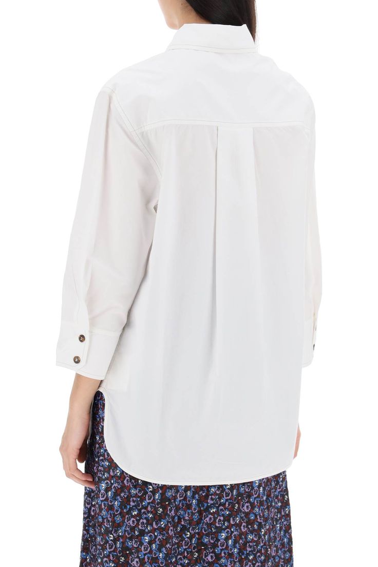 This Ganni shirt is made of organic cotton poplin and features an oversized fit. It has a collar, button closure, chest pocket, small tonal embroidered logo, side slits, and an asymmetrical cut. The model is 177 cm tall and wears size 34. Composition: 100% ORGANIC CO Relaxed Fit Long Sleeve Poplin Blouse, Fall Poplin Shirt, Oversized Cotton Blouse With Placket, Daywear Poplin Tops With Button Closure, Daywear Tops With Button Closure, Poplin Tops With Button Closure For Daywear, Relaxed Fit Poplin Tops With Button Cuffs, Casual Poplin Tops With Button Cuffs, Oversized Poplin Tops For Spring