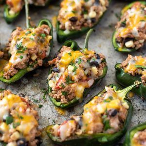 stuffed peppers with meat and vegetables on a baking sheet