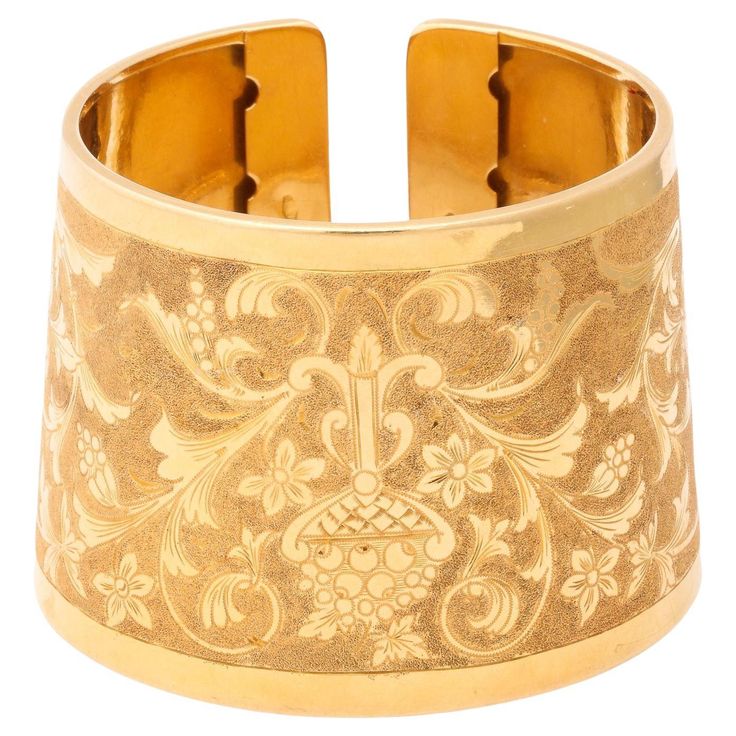 Italian 18 k Engraved Cuff with classical design of flowers and vines. This exceptional cuff can be worn on the wrist or the forearm it is beautifully executed and a one of a kind. It has a two-tone look. Ornate Yellow Gold Cuff Bracelet Gift, Ornate Yellow Gold Cuff Bracelet With Intricate Design, Luxury Victorian Gold Cuff Bracelet, Luxury Victorian Yellow Gold Cuff Bracelet, Luxury Gold-tone Cuff Bracelet With Jubilee Design, Design Of Flowers, Engraved Cuff, Classical Design, Cute Jewelry