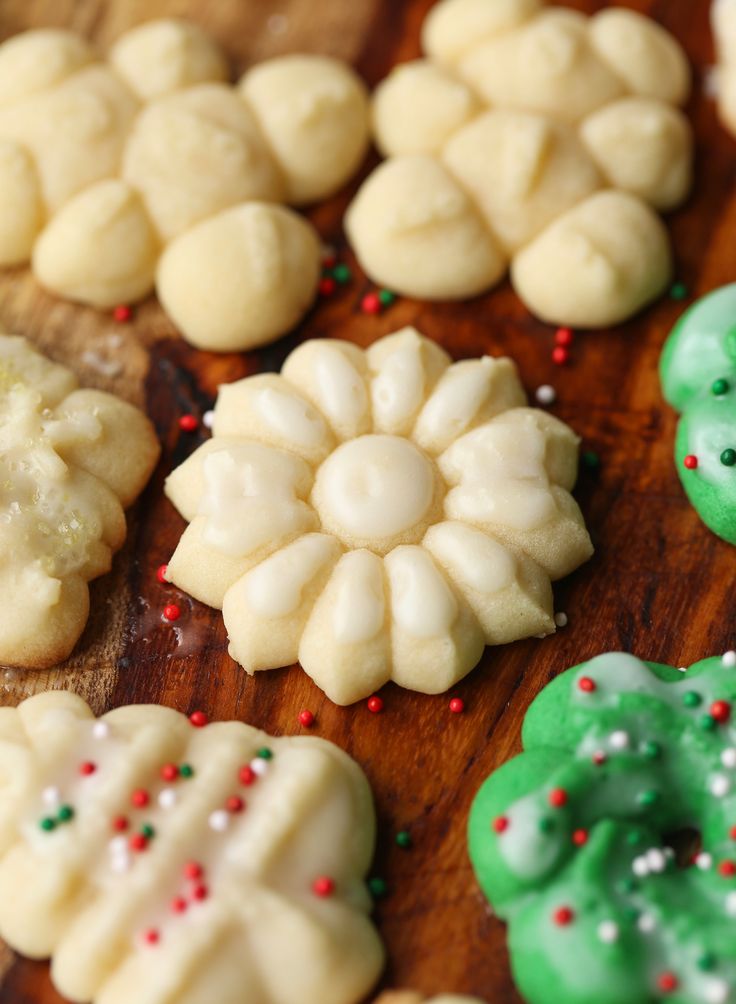 many different types of cookies on a wooden table