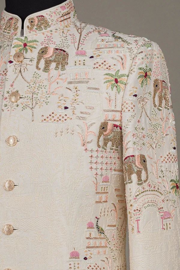 an embroidered jacket with elephants and palm trees on the front, along with other decorations