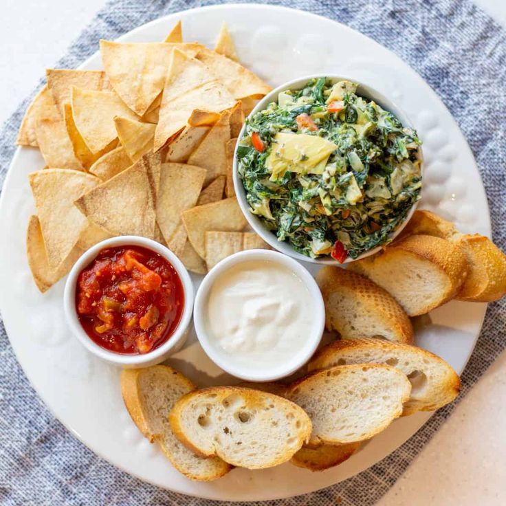 a white plate topped with chips and salsa