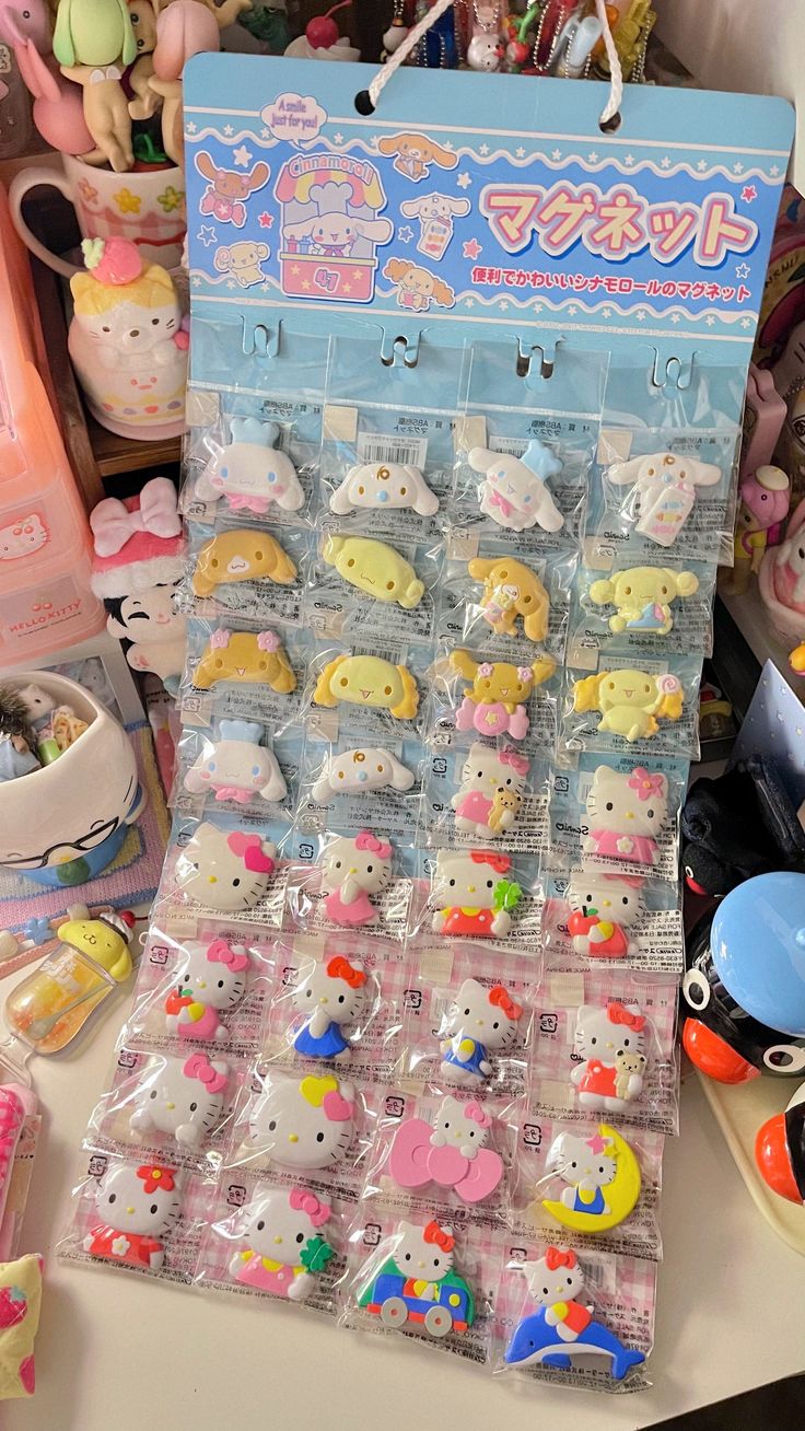 a bunch of hello kitty toys sitting on top of a table next to other items