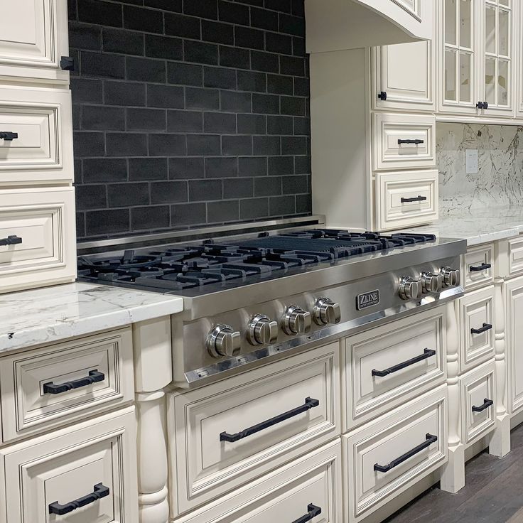 a kitchen with white cabinets and an oven