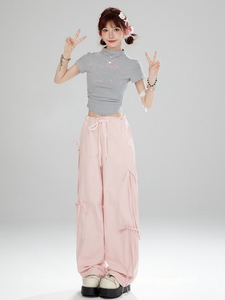 Elevate your kawaii wardrobe with these charming high-waist pink bowknots wide-leg cargo pants. The high waist design and adorable bowknot details add a touch of Lolita fashion to your look. Made with quality material, these wide-leg pants are comfortable and stylish, perfect for creating a sweet and elegant outfit.   Please note that this product includes only one pair of pants.   Garment Size   	 		 			Size 			S 			M 			L 			XL 		 		 			Full Length 			102 			104 			106 			108 		 		 			Waist 			79 			83 			87 			91 		 		 			Hips 			98 			102 			106 			110 Trendy Pink Parachute Pants For Spring, Pink High-waisted Cargo Pants For Summer, Trendy High Waist Pink Cargo Pants, Harajuku Style Bottoms With Pockets For Spring, Pink High Waist Parachute Pants For Spring, Pink Wide Leg Cargo Pants For Summer, Trendy Pink Wide Leg Parachute Pants, Pink Wide-leg Parachute Pants For Spring, Pink High-waisted Cotton Parachute Pants