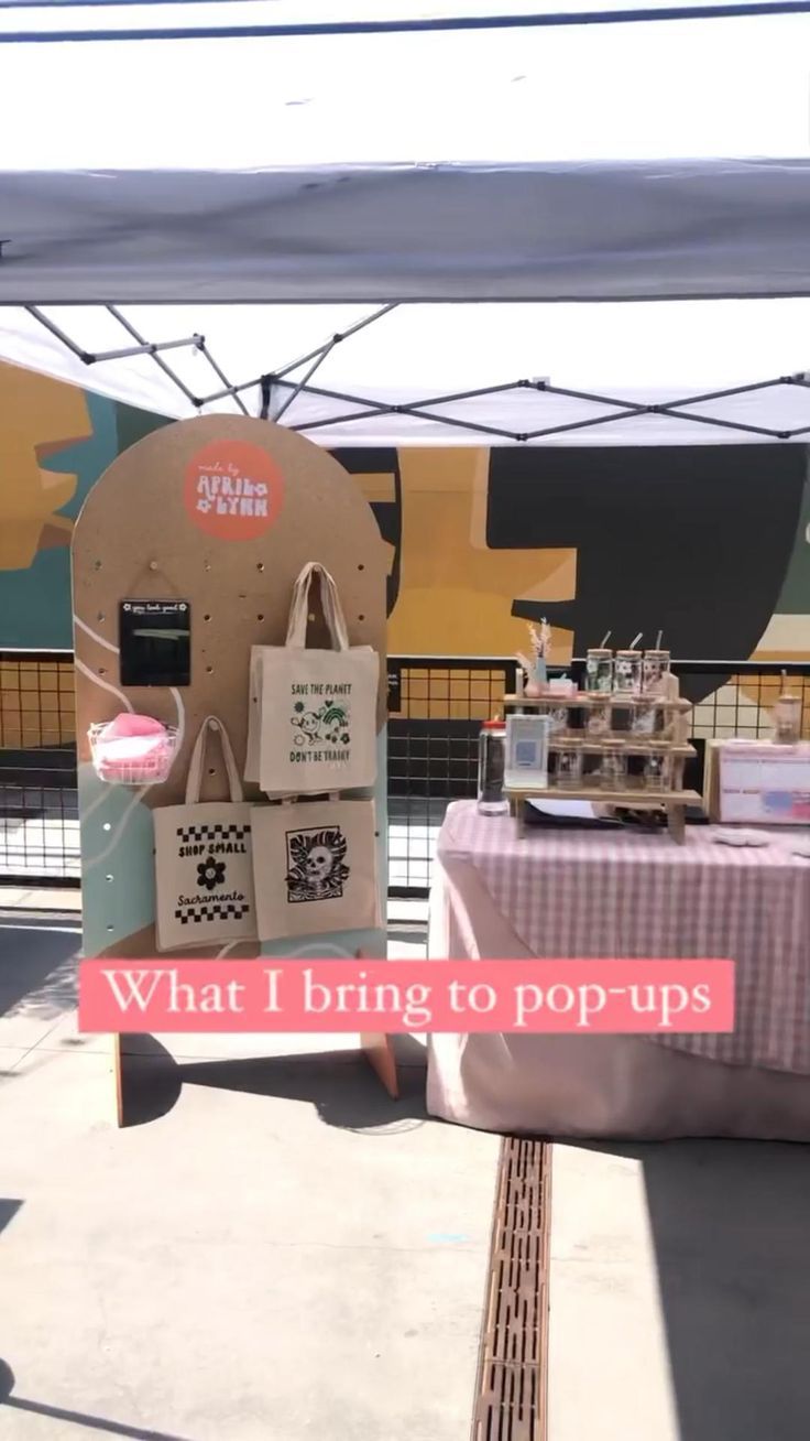 a table that has some bags on it and the words what i bring to pop - ups