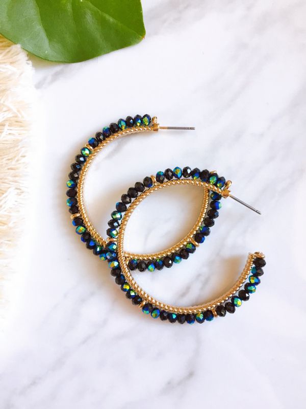 This stunning midnight beauty hoop earring are a beautiful accessory for any outfit. We love the beaded details of sparking black, navy blue, and aqua green. Depending on where the light hit will give a different color. Approximate length of earrings: 1.7/8" Materials have natural variations Colors may vary from different viewing device Also available other colors. Black Beaded Hoop Earrings For Party, Blue Hoop Earrings For Party, Black Small Hoop Jewelry For Parties, Black Small Hoop Earrings For Party, Trendy Blue Crystal Earrings For Party, Trendy Sparkling Hoop Earrings For Party, Green Hoop Earrings For Party, Small Hoop Beaded Earrings For Party, Party Small Hoop Beaded Earrings