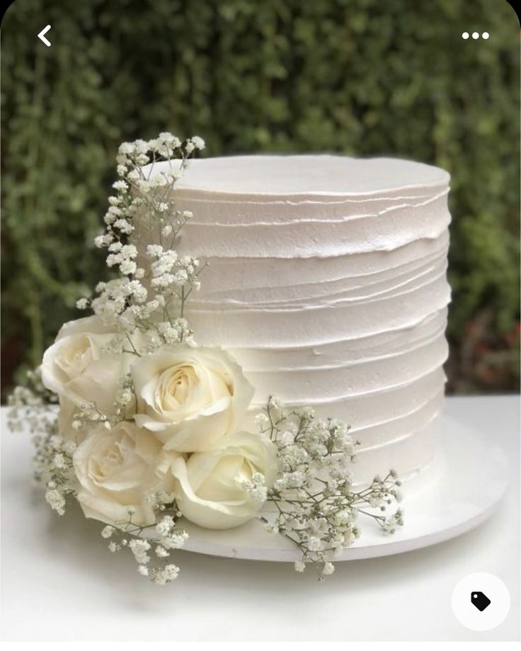 a white wedding cake with flowers on top