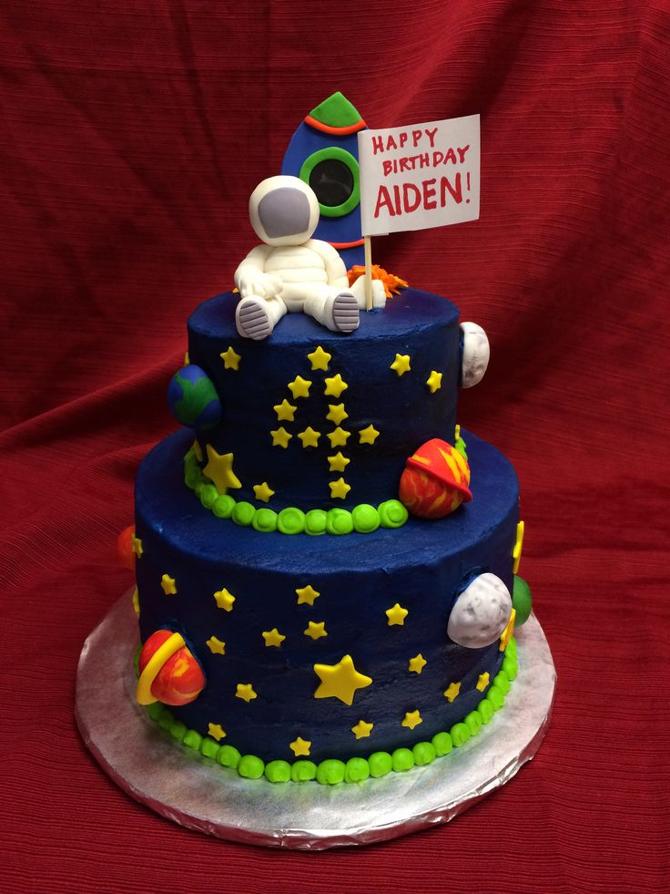 a birthday cake with an astronaut on top