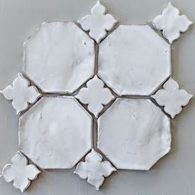 a white tile design on the wall