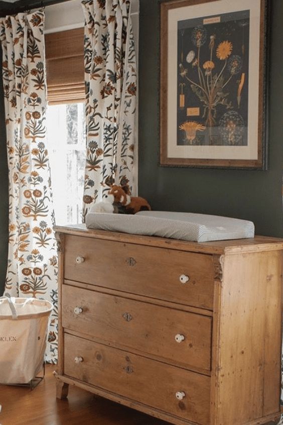 a baby's crib in the corner of a room with curtains and drapes