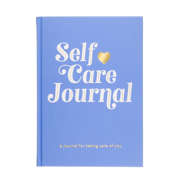 a blue book with the words self care journal written in white on it and a gold heart