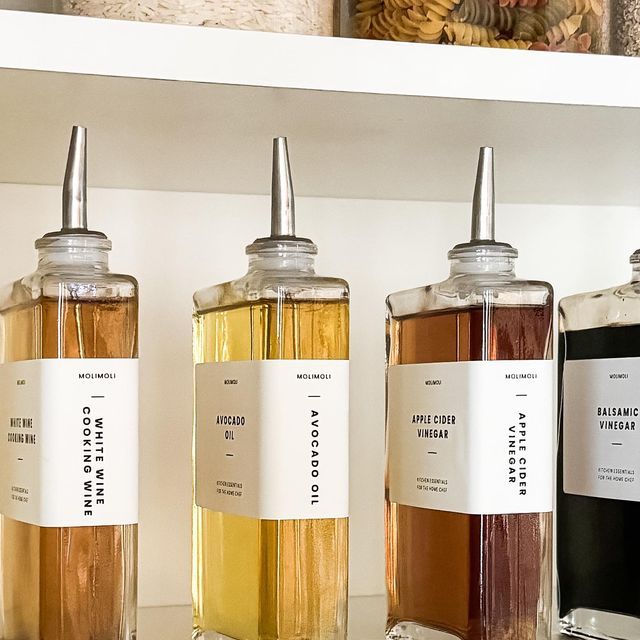 three bottles of different colored liquids on a shelf