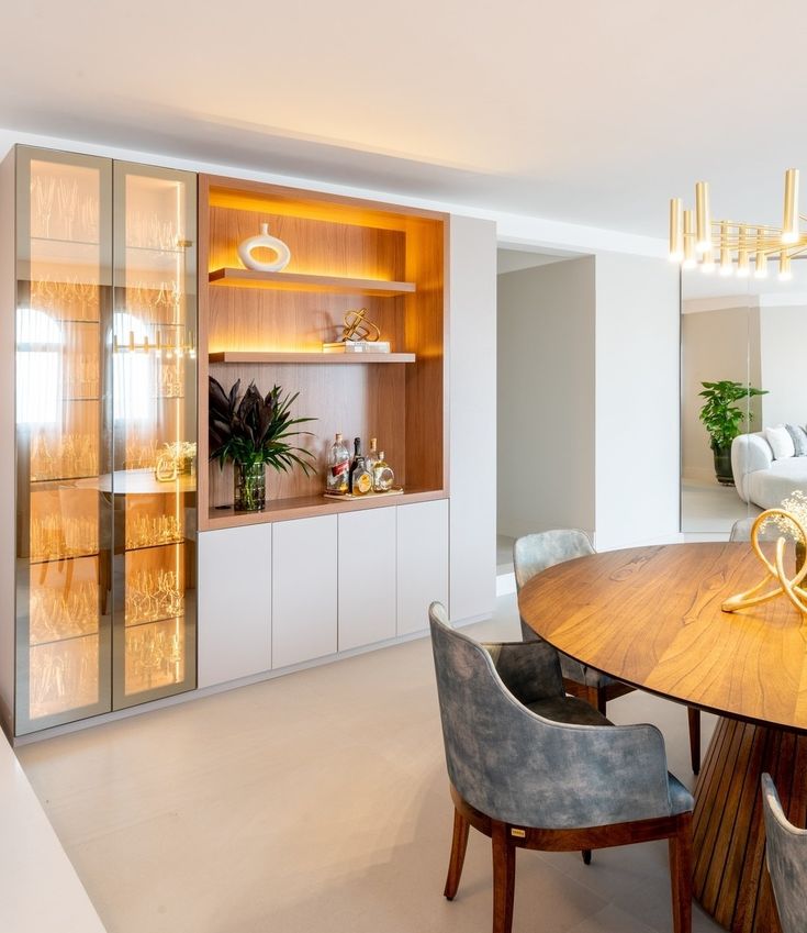 the dining room table is surrounded by chairs and cupboards with built - in shelving