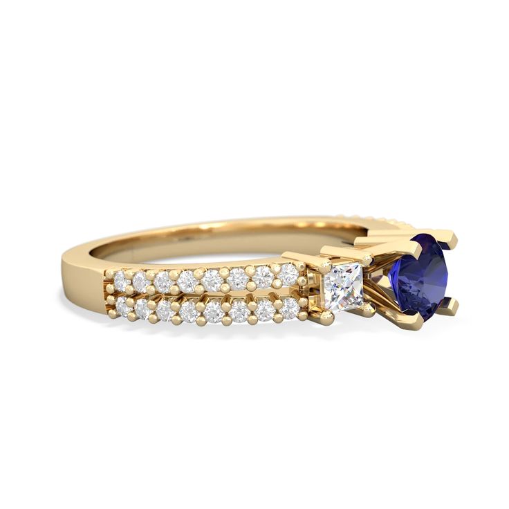 a yellow gold ring with an oval blue sapphire and two small white diamonds on the side