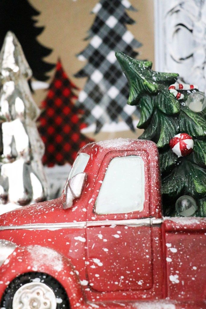 a red truck with a christmas tree in the back