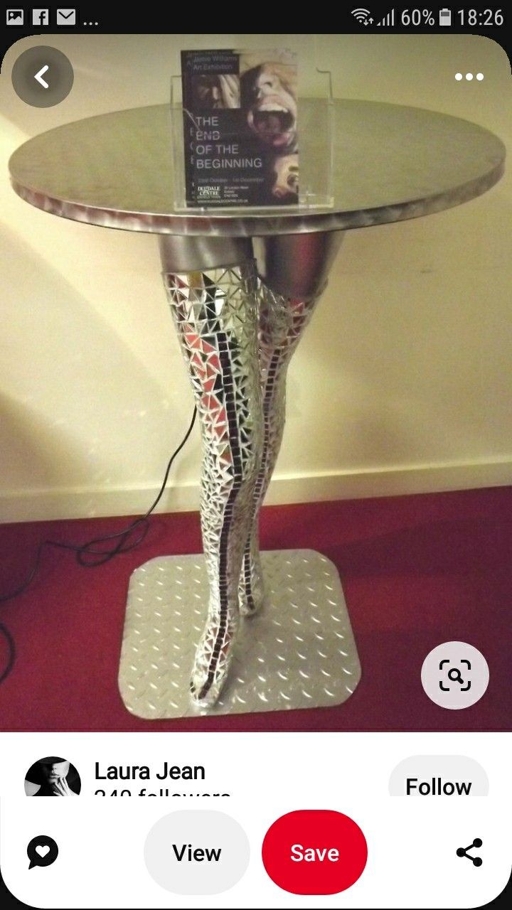 a table that has some kind of book on top of it with an image of a woman's legs