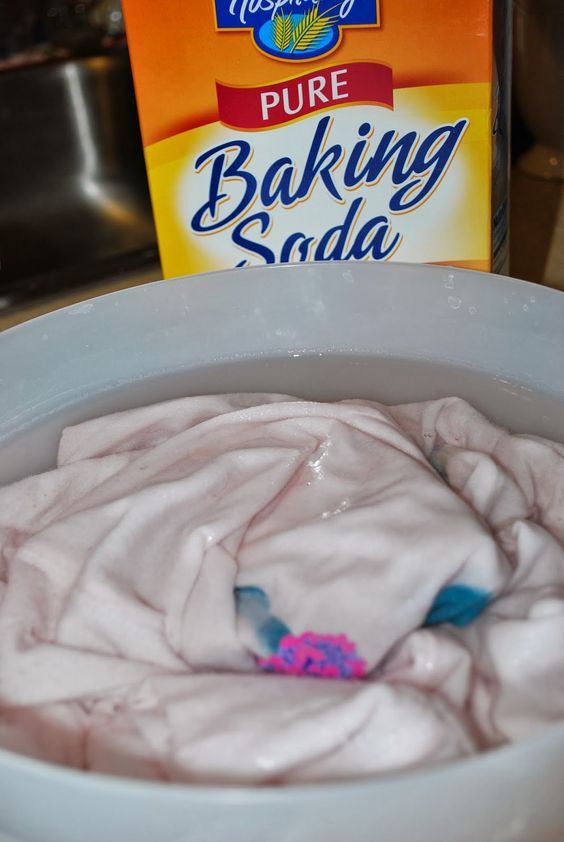 a box of baking soda sitting on top of a white bowl