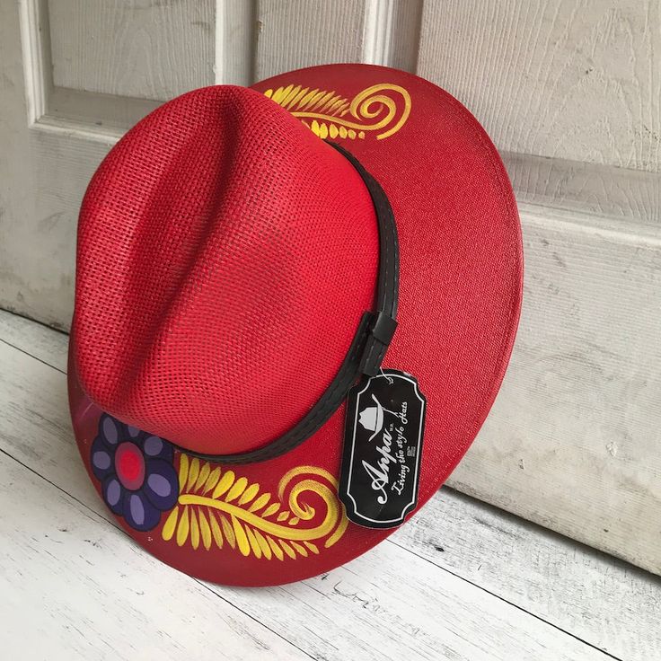 Stay stylish in this beautiful colorful hand painted straw hat, ideal for any sunny day occasion. Every single hat is hand painted uniquely which means there will never be another one like it. MADE IN MEXICO By: Mexican Artisans For: Women Size: Large (23.5") Color: red | multi Details: Material: Palm Straw Leather Band Inner elastic band Contact us for more details PLEASE READ BEFORE PURCHASE: The picture is an ACCURATE REPRESENTATION. Colors in the pictures may vary a little by effects of ligh Adjustable Curved Brim Straw Hat As Gift, Adjustable Brimmed Straw Hat As Gift, Hand Painted Artisan Fedora For Summer, Whimsical Handmade Summer Fedora, Adjustable Hand Painted Sun Hat With Flat Brim, Hand Painted Fedora Hats For Summer, Hand Painted Flat Brim Fedora For Summer, Beach Hats With Hand Painted Adjustable Design, Hand Painted Panama Hat With Short Brim For Summer