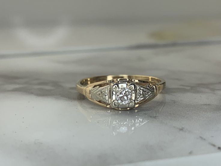 a diamond ring sitting on top of a marble counter