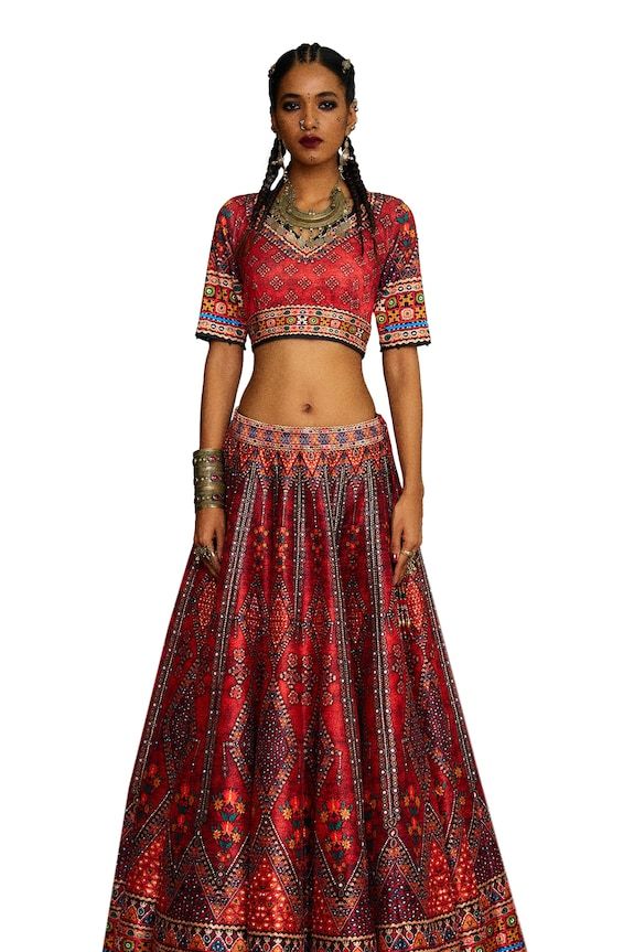 Red V-neck blouse with tribal print and threads, beads embroidery. Paired with coordinating lehenga and dupatta. - Aza Fashions Traditional V-neck Choli With Intricate Embroidery, Bohemian V-neck Unstitched Choli, Traditional V-neck Choli With Resham Embroidery, Traditional Silk V-neck Choli, Red Unstitched Blouse Choli For Festival, Red Unstitched Choli For Festival, Festive Bohemian V-neck Choli, Red Lehenga With Resham Embroidery For Festival, Bohemian Silk Choli With Resham Embroidery