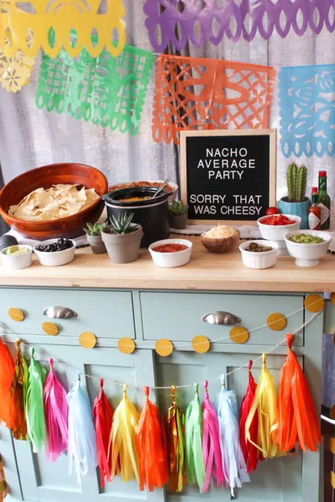 a buffet table with tassels and food on the top, in front of a sign that says nacho de party sorry