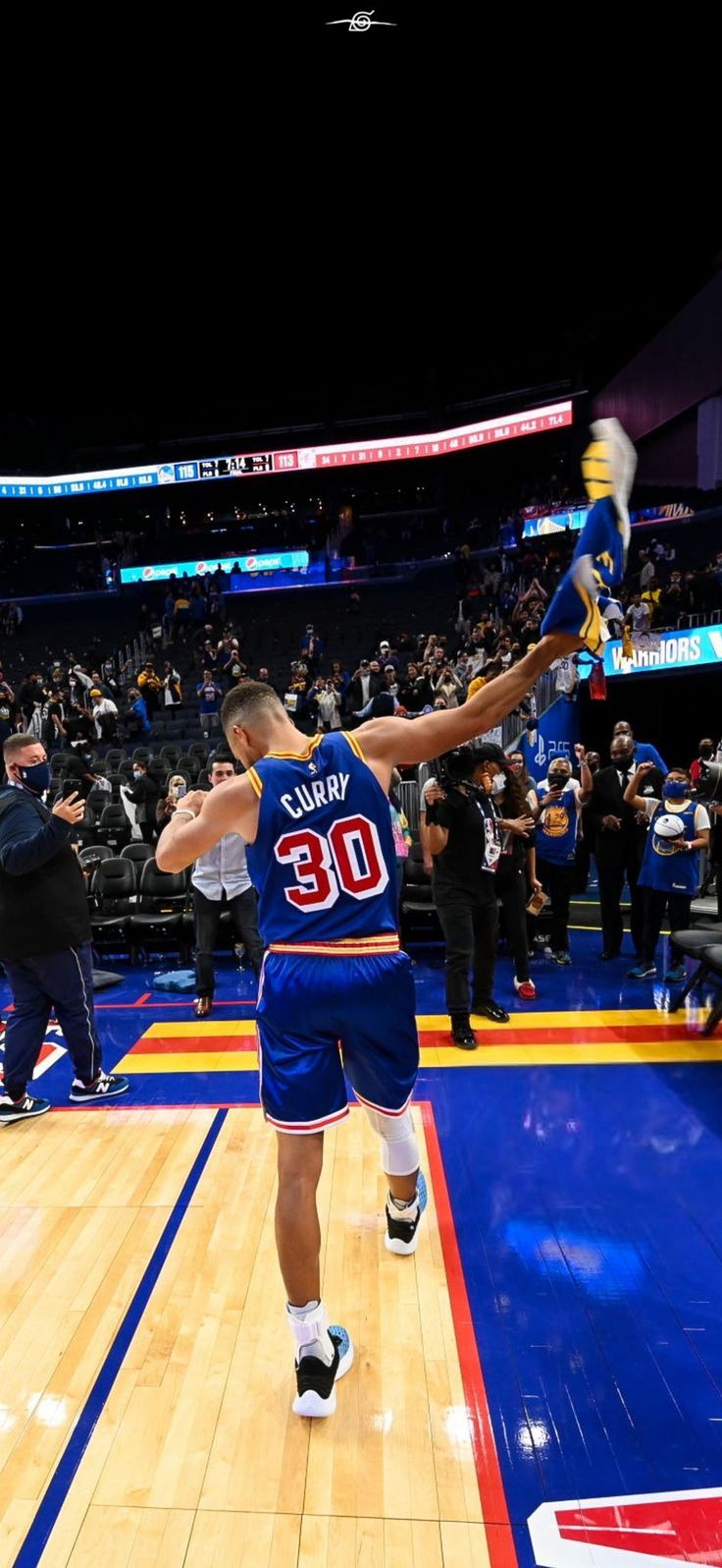 a basketball player is jumping up in the air to dunk at an arena full of people