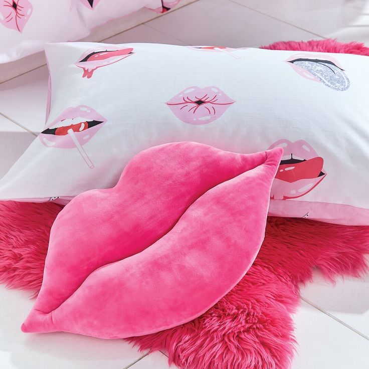 pink pillows with flamingos on them are laying on the floor